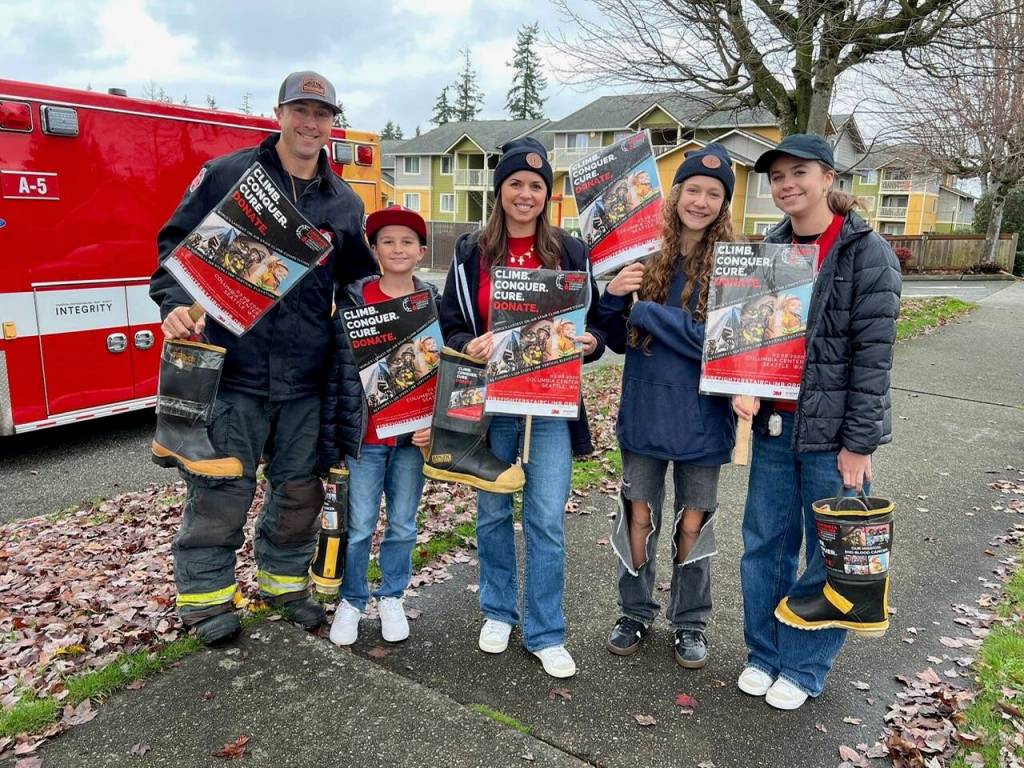 During a Fill the Boot event in Everett, Washington (from left to right) Everett Fire Captain D.J. Neyens, his son Maddox Neyens, wife Lindsey Neyens, family friend Lila Morehead and daughter Olivia Neyens collect Firefighter Stairclimb donations. (Photo courtesy of D.J. Neyens)