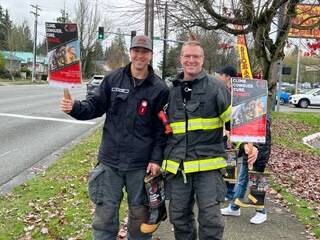 Everett Fire Captain D.J. Neyens (left) and firefighter Pete Stelling collect Firefighter Stairclimb donations during a Fill the Boot event in Everett, Washington. (Photo courtesy of D.J. Neyens)