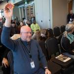People that found Dave and Busters rewards under their chairs raise their hands during the State of the City event at the Lynnwood Neighborhood Center on Thursday, March 26, 2026 in Lynnwood, Washington. (Olivia Vanni / The Herald)