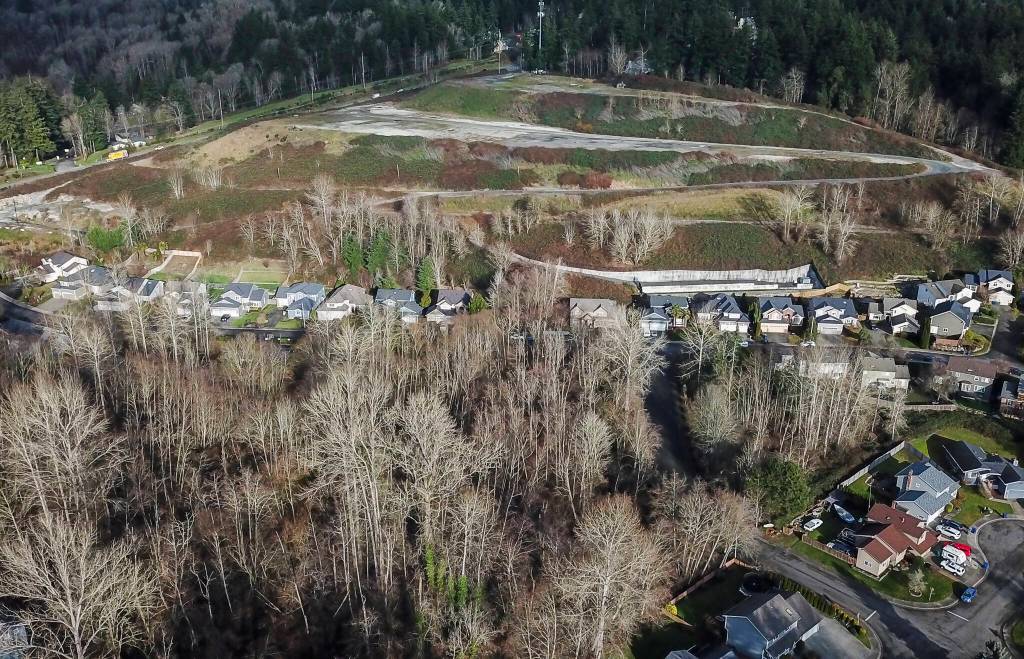 Homes line the base of the 228th Street development site on Wednesday, Jan. 8, 2025 in Bothell, Washington. (Olivia Vanni / The Herald)