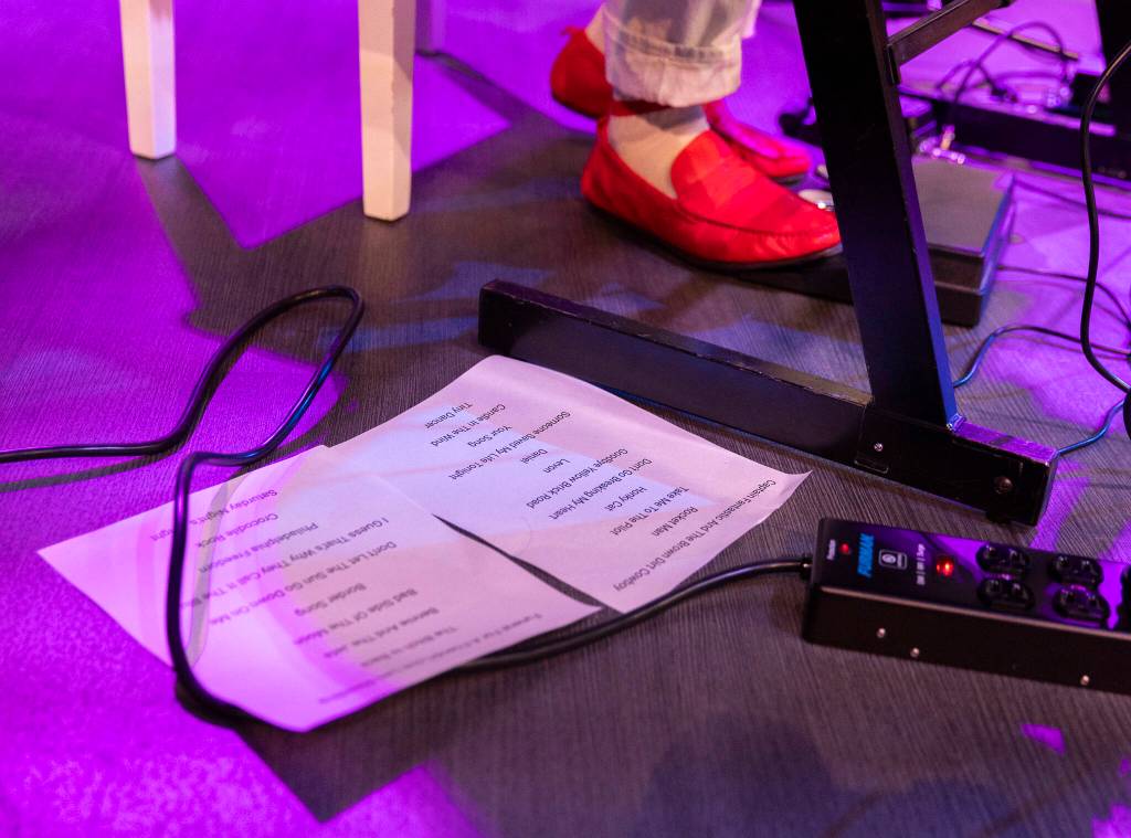 The set list lays on the ground next to the bright red shoes of  Elton John tribute band called Madman Across the Water singer Andrew Vait on Thursday, June 26, 2025 in Tulalip, Washington. (Olivia Vanni / The Herald)