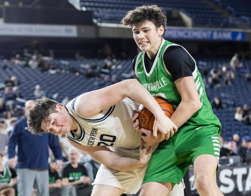 Glacier Peaks Zachary Albright and Woodinvilles Rowan Kelly fight for a rebound during the 4A state game on Wednesday, March 4, 2026 in Tacoma, Washington. (Olivia Vanni / The Herald)