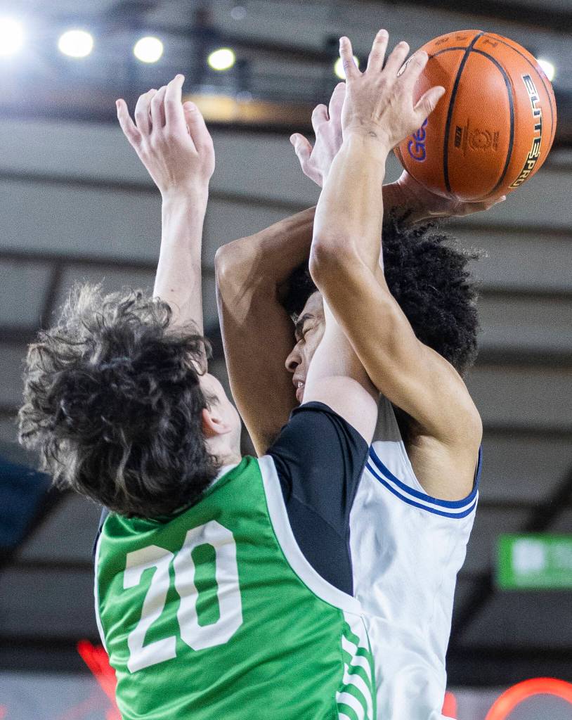 Glacier Peaks Justin Vinson is fouled by Woodinvilles Rowan Kelly during the 4A state game on Wednesday, March 4, 2026 in Tacoma, Washington. (Olivia Vanni / The Herald)
