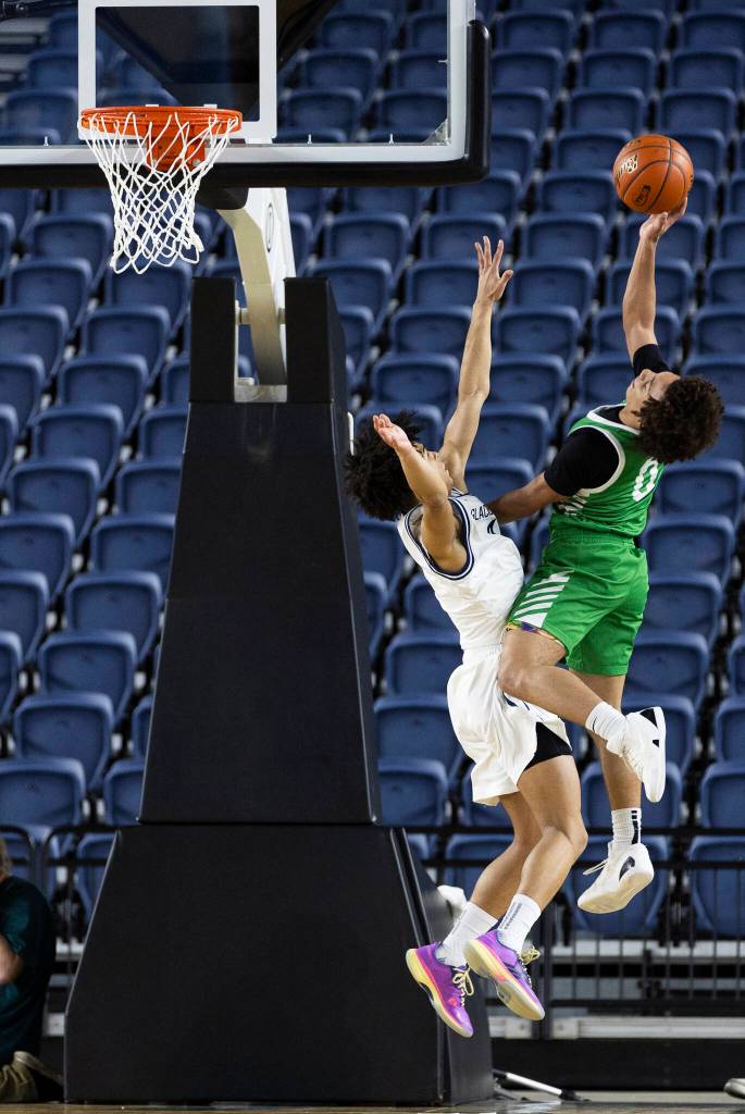 Glacier Peaks Justin Vinson jumps to block a shot by Woodinvilles Elijah Price during the 4A state game on Wednesday, March 4, 2026 in Tacoma, Washington. (Olivia Vanni / The Herald)