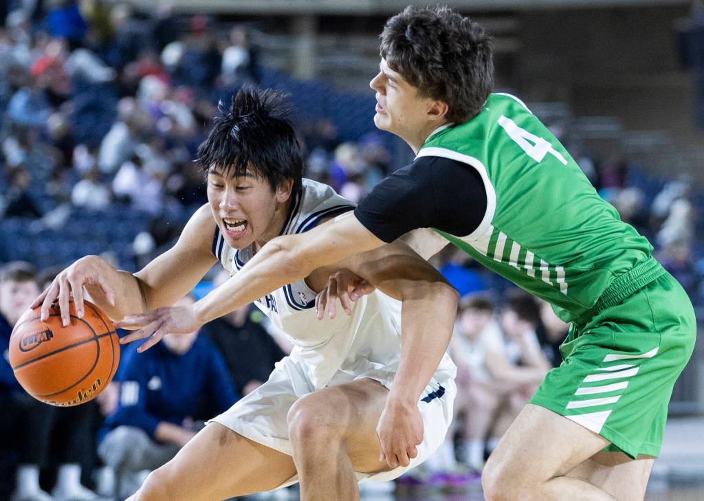Glacier Peaks Edison Kan tries to keep possession of the ball while Woodinvilles Dexter Chastney defends during the 4A state game on Wednesday, March 4, 2026 in Tacoma, Washington. (Olivia Vanni / The Herald)