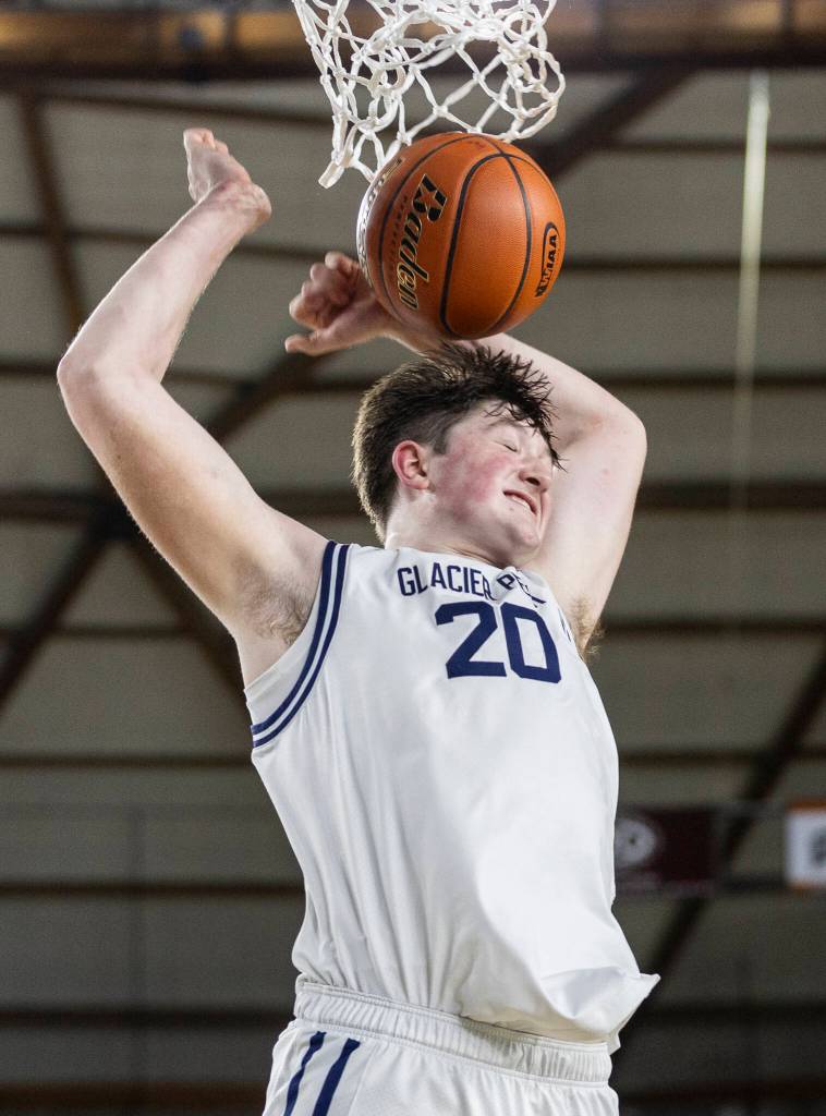 Glacier Peaks Zachary Albright smiles after dunking the ball during the 4A state game against Woodinville on Wednesday, March 4, 2026 in Tacoma, Washington. (Olivia Vanni / The Herald)