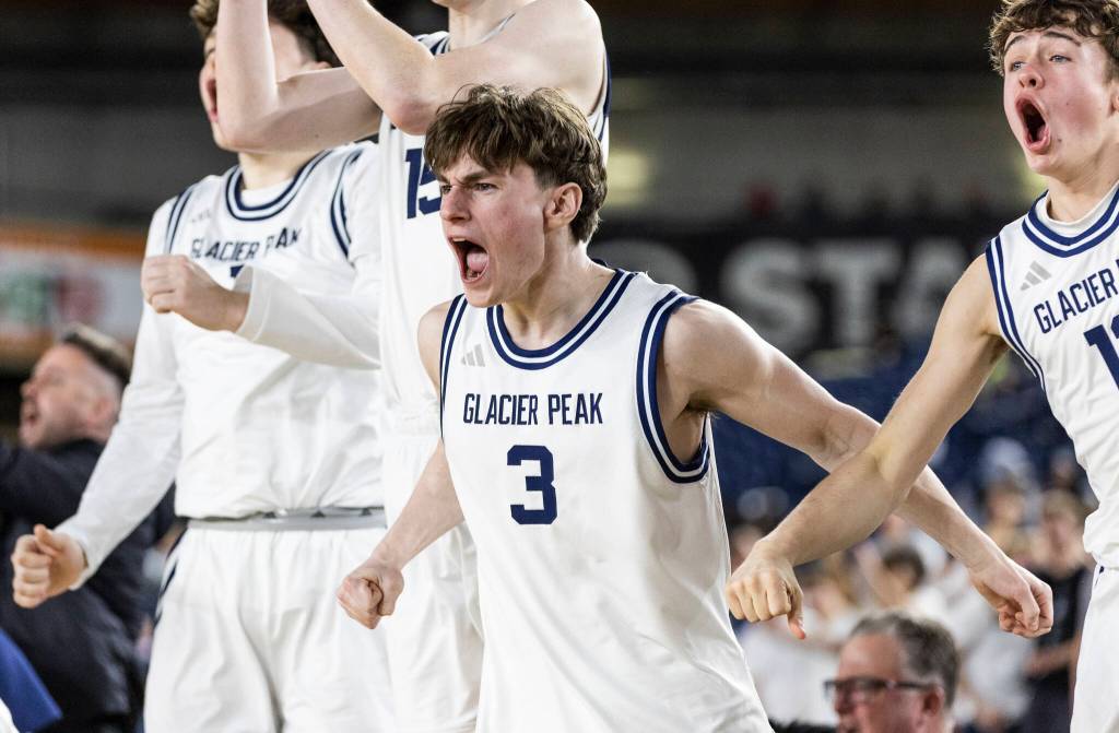 Glacier Peaks Reece Rondeau reacts to a dunk by teammate Zachary Albright during the 4A state game against Woodinville on Wednesday, March 4, 2026 in Tacoma, Washington. (Olivia Vanni / The Herald)