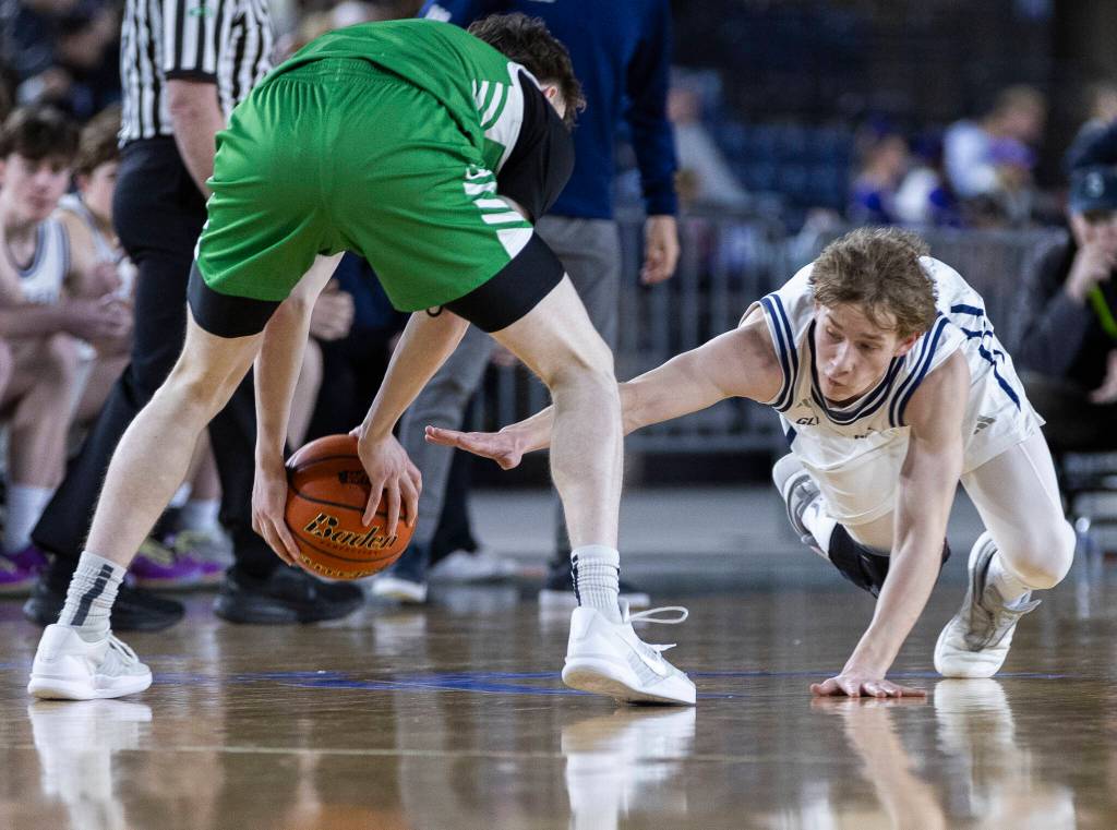 Glacier Peaks Reed Nagel scrambles for a loose ball during the 4A state game against Woodinville on Wednesday, March 4, 2026 in Tacoma, Washington. (Olivia Vanni / The Herald)