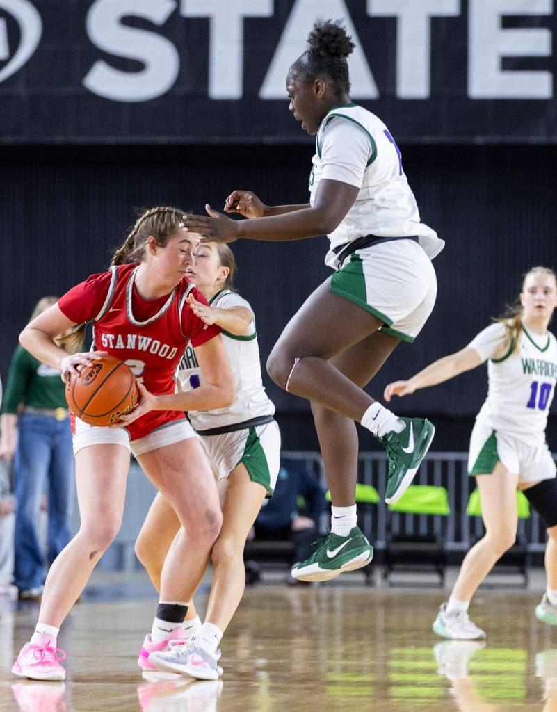 Edmonds-Woodways Zaniyah Jones jumps in the air while trying to defend Stanwoods Ellalee Wortham during the 3A state game on Wednesday, March 4, 2026 in Tacoma, Washington. (Olivia Vanni / The Herald)