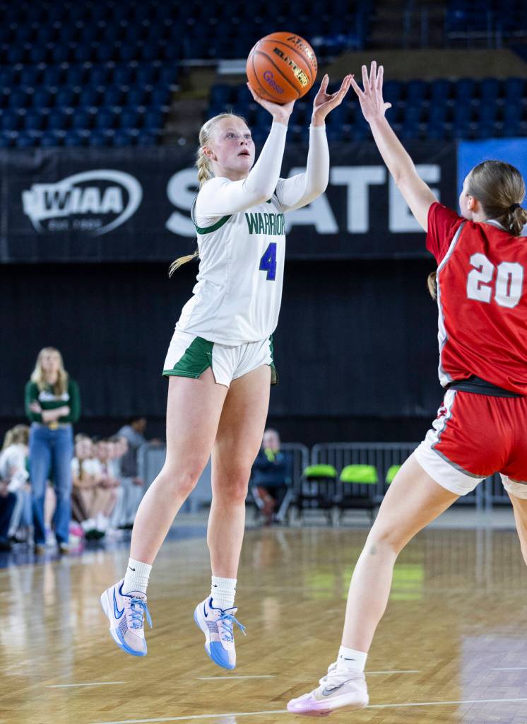 Edmonds-Woodways Finley Wichers takes a three-point shot while Stanwoods Presley Harris defends during the 3A state game on Wednesday, March 4, 2026 in Tacoma, Washington. (Olivia Vanni / The Herald)