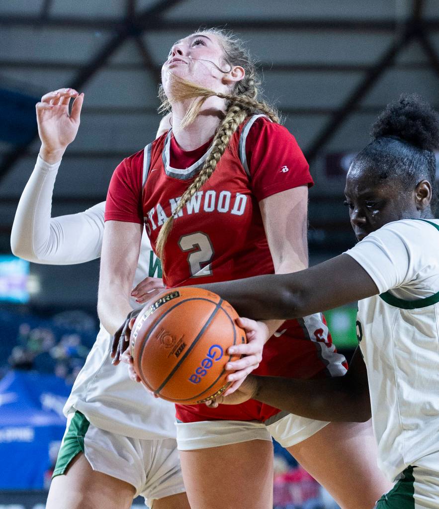 Stanwoods Ellalee Wortham is fouled by Edmonds-Woodways Finley Wichers during the 3A state game on Wednesday, March 4, 2026 in Tacoma, Washington. (Olivia Vanni / The Herald)