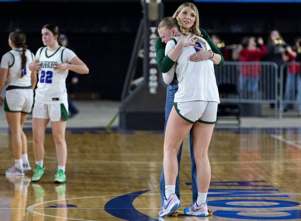 Edmonds-Woodways Finley Wichers hug Edmonds-Woodway head coach Quinn Manning after losing to Stanwood in the 3A state game on Wednesday, March 4, 2026 in Tacoma, Washington. (Olivia Vanni / The Herald)