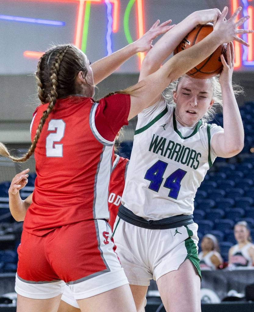 Edmonds-Woodways Amelia Faber tries to keep possession of the ball while Stanwoods Ellalee Wortham defends during the 3A state game on Wednesday, March 4, 2026 in Tacoma, Washington. (Olivia Vanni / The Herald)