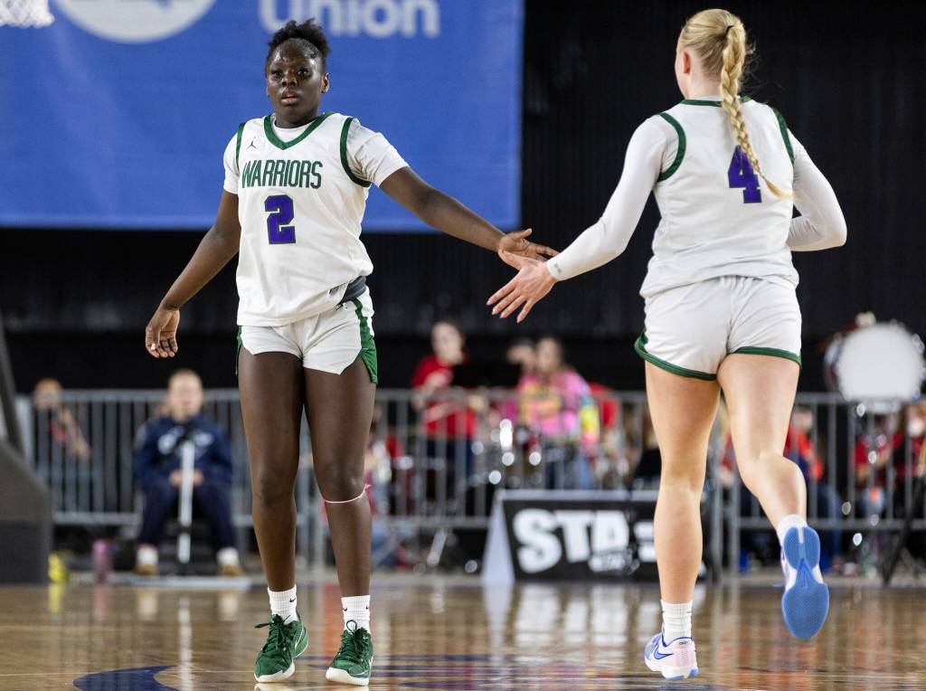 Edmonds-Woodways Zaniyah Jones high fives teammate Finley Wichers during the 3A state game against Stanwood on Wednesday, March 4, 2026 in Tacoma, Washington. (Olivia Vanni / The Herald)