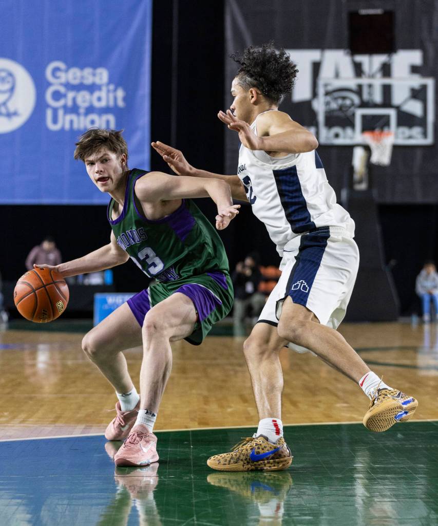 Edmonds-Woodways Dennis Karl dribbles the ball during the 3A state quarterfinal game Bellarmine Prep on Thursday, March 5, 2026 in Tacoma, Washington. (Olivia Vanni / The Herald)