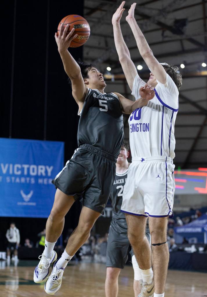 Glacier Peaks Edison Kan tries to layup the ball while Lake Washingtons Julien Deblieck defends during the 4A state quarterfinal game on Thursday, March 5, 2026 in Tacoma, Washington. (Olivia Vanni / The Herald)
