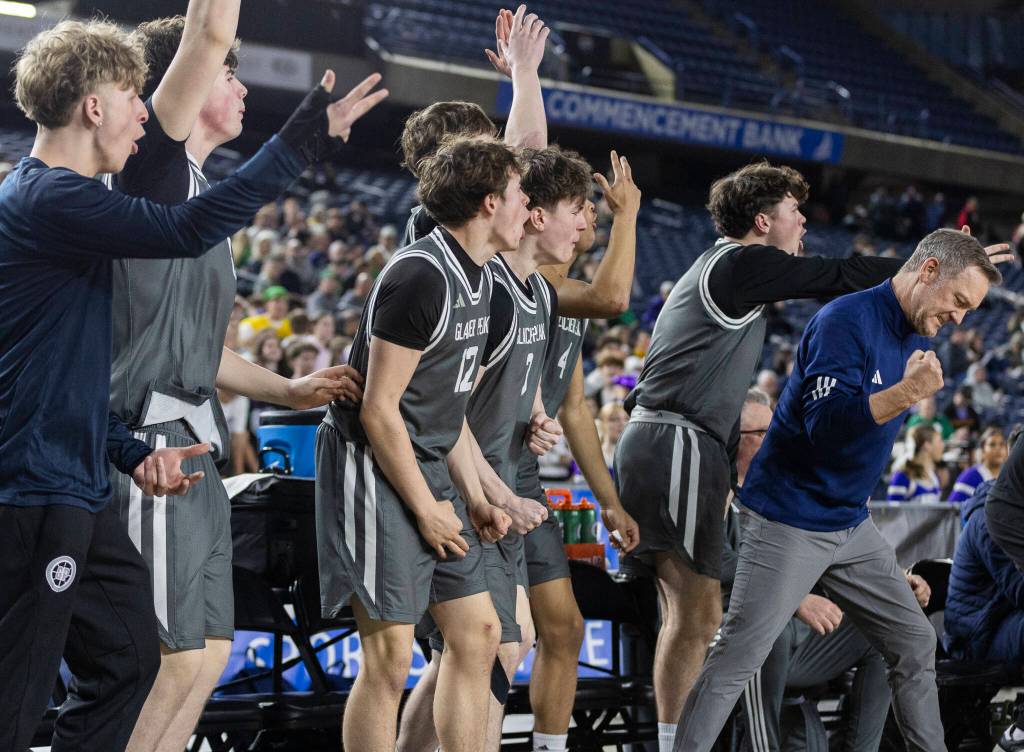 The Glacier Peak bench reacts to Glacier Peaks Paulos Mulugeta hitting a three-point shot during the 4A state quarterfinal game against Lake Washington on Thursday, March 5, 2026 in Tacoma, Washington. (Olivia Vanni / The Herald)