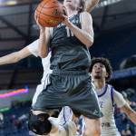 Glacier Peaks Reed Nagel jumps while attempting a layup during the 4A state quarterfinal game against Lake Washington on Thursday, March 5, 2026 in Tacoma, Washington. (Olivia Vanni / The Herald)