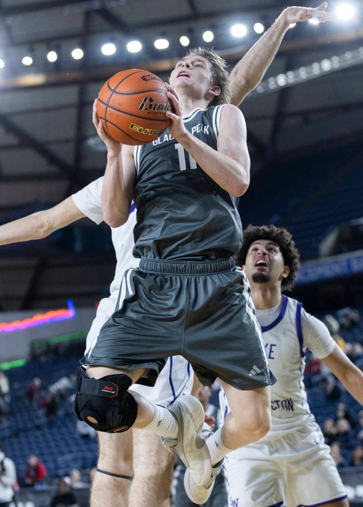 Glacier Peaks Reed Nagel jumps while attempting a layup during the 4A state quarterfinal game against Lake Washington on Thursday, March 5, 2026 in Tacoma, Washington. (Olivia Vanni / The Herald)