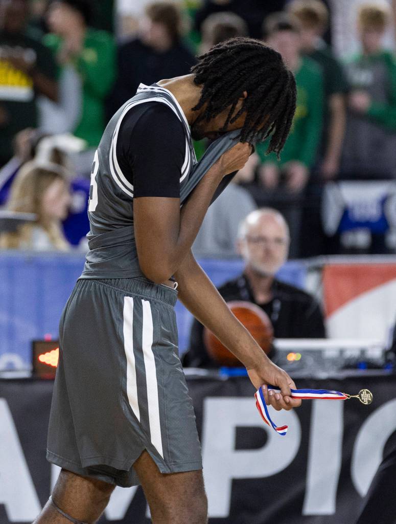 Glacier Peaks Paulos Mulugeta wipes his face after losing in the 4A state quarterfinal game against Lake Washington on Thursday, March 5, 2026 in Tacoma, Washington. (Olivia Vanni / The Herald)