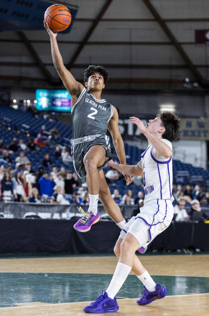 Glacier Peaks Aaron Thomas lays up the ball while Lake Washingtons Jayden Hunt defends during the 4A state quarterfinal game on Thursday, March 5, 2026 in Tacoma, Washington. (Olivia Vanni / The Herald)