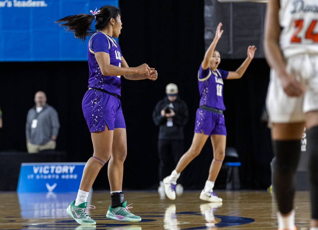 Lake Stevens Noelani Tupua reacts after hitting a half-court shot at the halftime buzzer during the 4A state quarterfinal game against Davis on Thursday, March 5, 2026 in Tacoma, Washington. (Olivia Vanni / The Herald)
