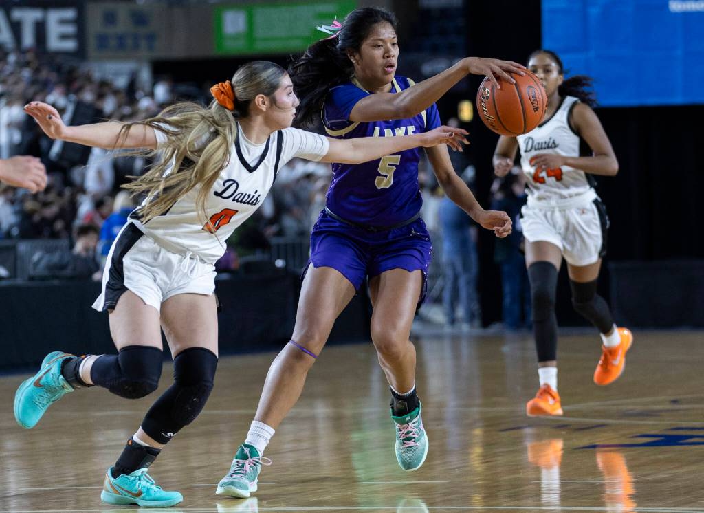 Lake Stevens Noelani Tupua tries to keep possession of the ball during the 4A state quarterfinal game against Davis on Thursday, March 5, 2026 in Tacoma, Washington. (Olivia Vanni / The Herald)