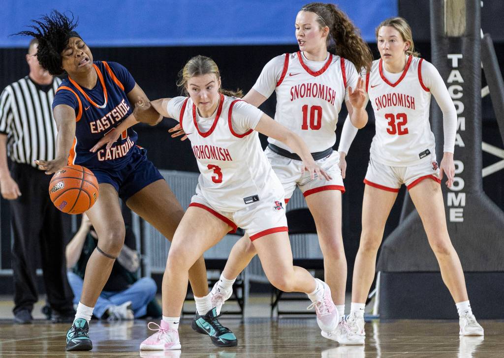 Eastside Catholics Amy Nduka grabs the arm of Snohomishs Kendall Hammer during 3A state semifinal game on Friday, March 6, 2026 in Tacoma, Washington. (Olivia Vanni / The Herald)