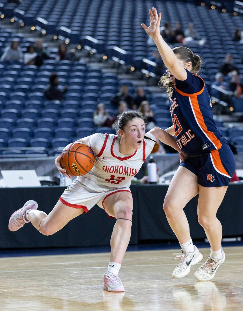Snohomishs Sienna Capelli drives to the hoop while Eastside Catholics Raquel Dunnam defends during 3A state semifinal game on Friday, March 6, 2026 in Tacoma, Washington. (Olivia Vanni / The Herald)