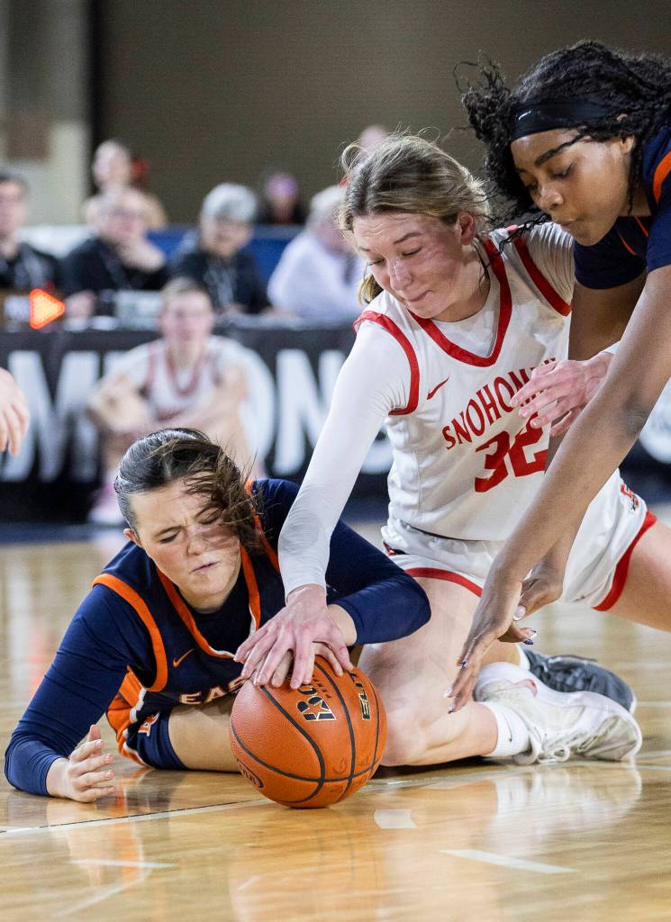 Snohomishs Lola Rotondo and Eastside Catholics Talia Cermak dives for a loose ball during 3A state semifinal game on Friday, March 6, 2026 in Tacoma, Washington. (Olivia Vanni / The Herald)