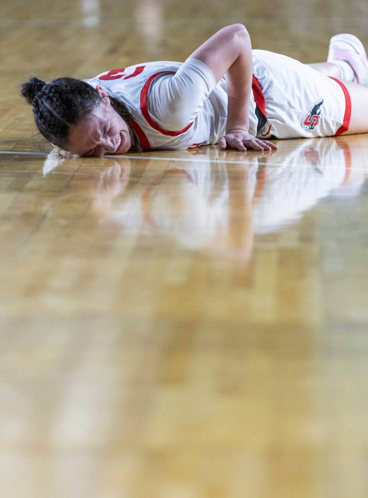Snohomishs Sienna Capelli grimaces after falling to the floor during 3A state semifinal game against Eastside Catholic on Friday, March 6, 2026 in Tacoma, Washington. (Olivia Vanni / The Herald)