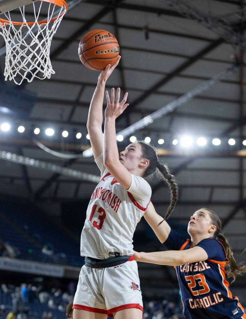 Snohomishs Sienna Capelli shoots a layup while Eastside Catholics Raquel Dunnam defends during 3A state semifinal game on Friday, March 6, 2026 in Tacoma, Washington. (Olivia Vanni / The Herald)