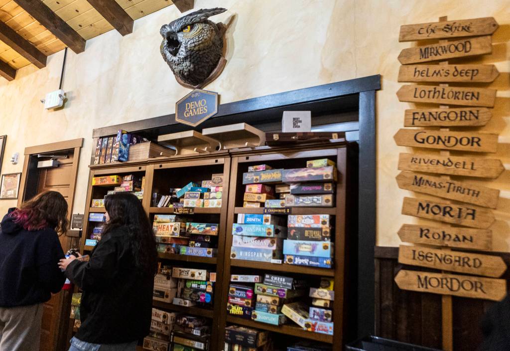 People browse the demo game selection at Zulu’s Board Game Cafe on Friday, Jan. 9, 2026 in Bothell, Washington. (Olivia Vanni / The Herald)