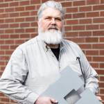 Jon Bauer, the Everett Herald’s opinion editor and Herald employee for over 24 years, outside the newspapers new office building along Hewitt Avenue on Tuesday, March 10, 2026 in Everett, Washington. (Olivia Vanni / The Herald)