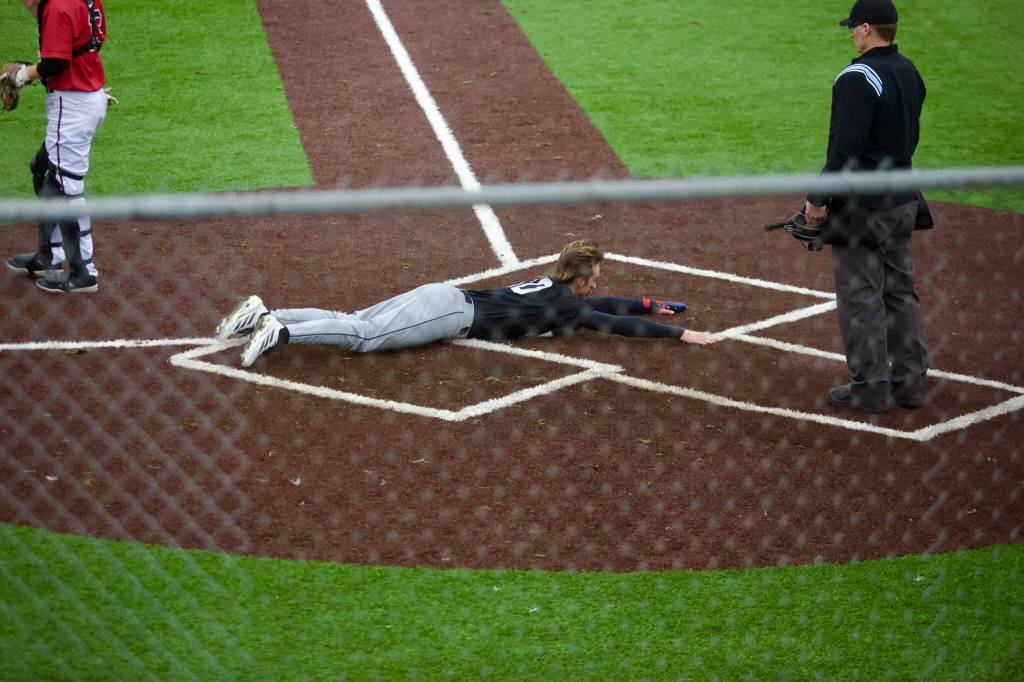 Kamiak senior Jonah Swardstrom slides safely into home during the Knights 6-5 loss to Snohomish at Geiger Field on March 11, 2026. (Joe Pohoryles / The Herald)