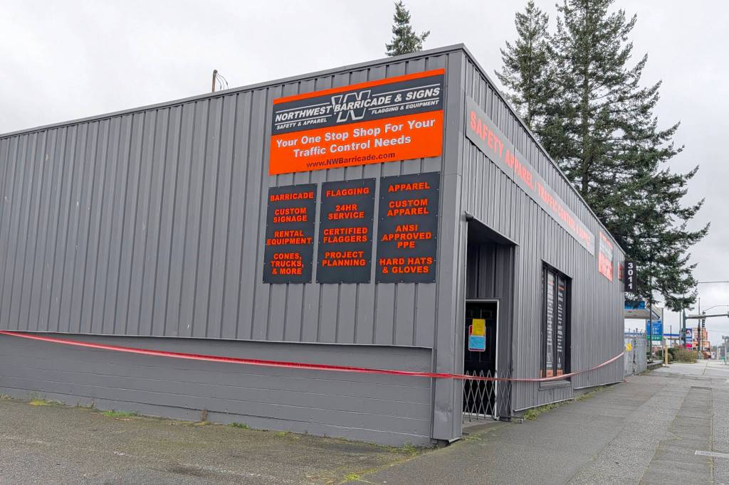 Red caution tape surrounds Northwest Barricade & Signs on Wednesday, March 18, 2026, in Everett, Washington. (Michael Henneke / The Herald)