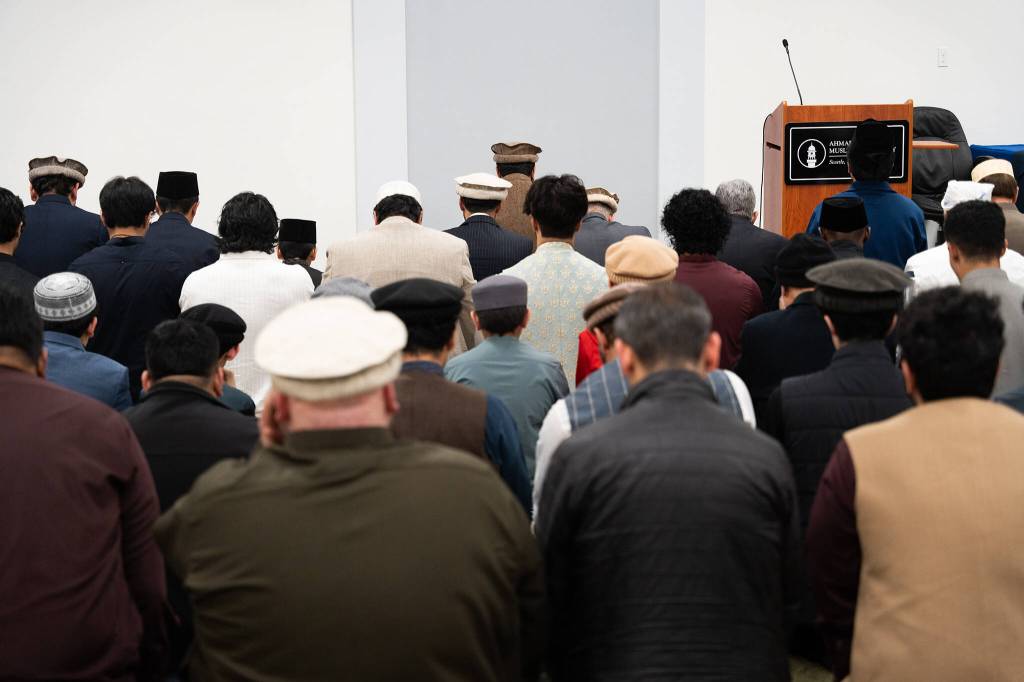 People pray during Eid al-Fitr celebrations on Friday in Monroe.
