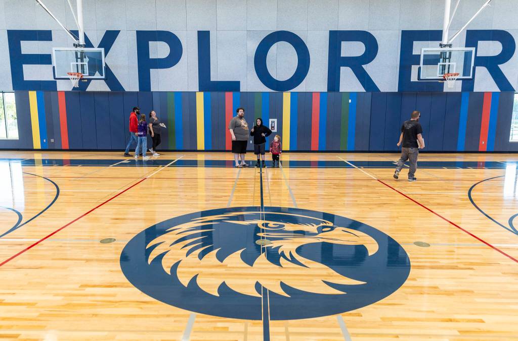 People walk through Explorer Middle Schools new gymnasium during an open house on Oct. 7 in Everett. (Olivia Vanni / The Herald)