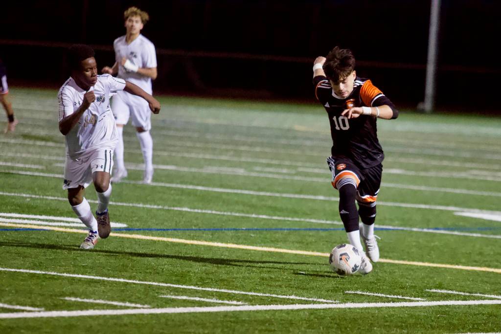 Monroe senior Julian Perez (right) dribbles into space during the Bearcats 2-0 win against Marysville Getchell at Monroe High School on March 24, 2026. (Joe Pohoryles / The Herald)