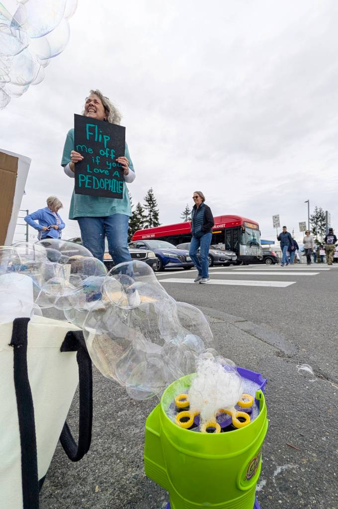 A No Kings Day rally included a bubble machine on Saturday, March 28, 2026, in Everett. Washington. (Michael Henneke / The Herald)