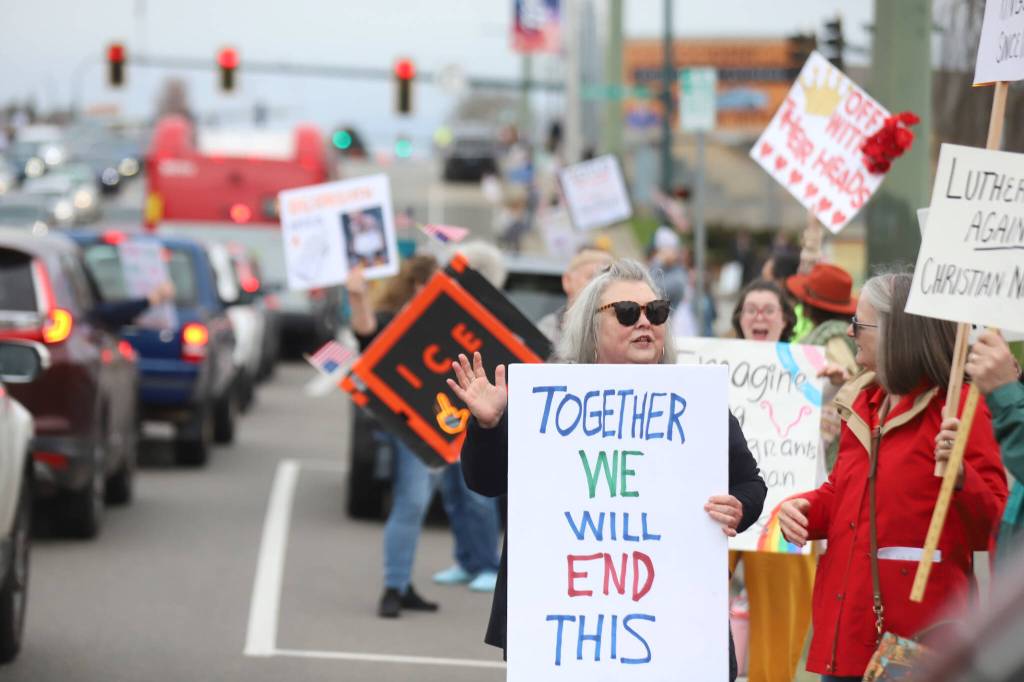 Protesters gather on Broadway during a No Kings Day rally on Saturday in Everett. (Michael Henneke / The Herald)
