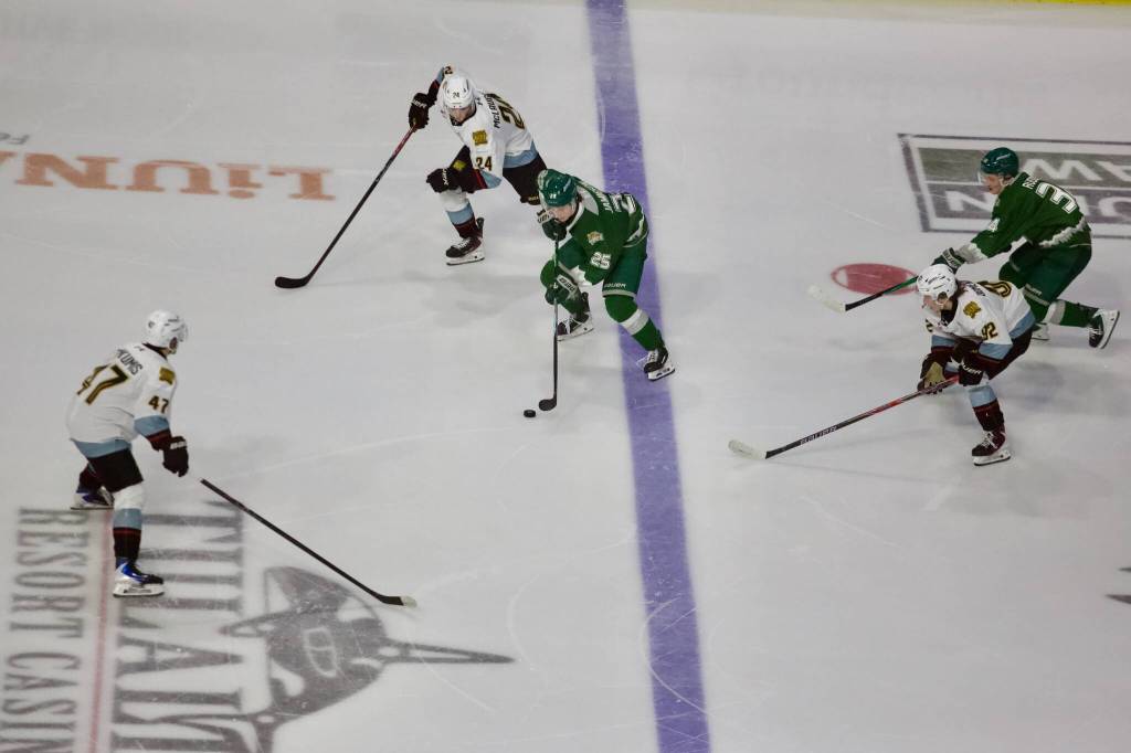 Silvertips forward Rhys Jamieson enters the offensive zone surrounded by defenders during Everetts 4-1 win against the Portland Winterhawks in Game 2 of the WHL Playoffs First Round at Angel of the Winds Arena on March 28, 2026. (Joe Pohoryles / The Herald)