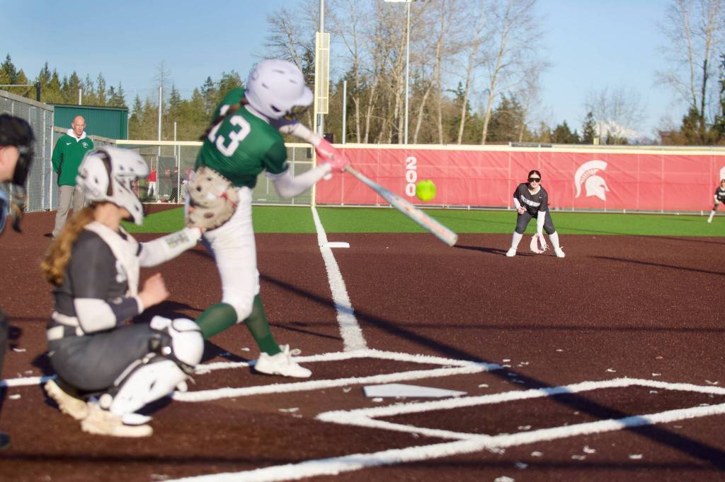 Edmonds-Woodway freshman Bella Swanson makes contact during the Warriors 7-1 loss to Stanwood at Mike Chandler Field on March 30, 2026. (Joe Pohoryles / The Herald)