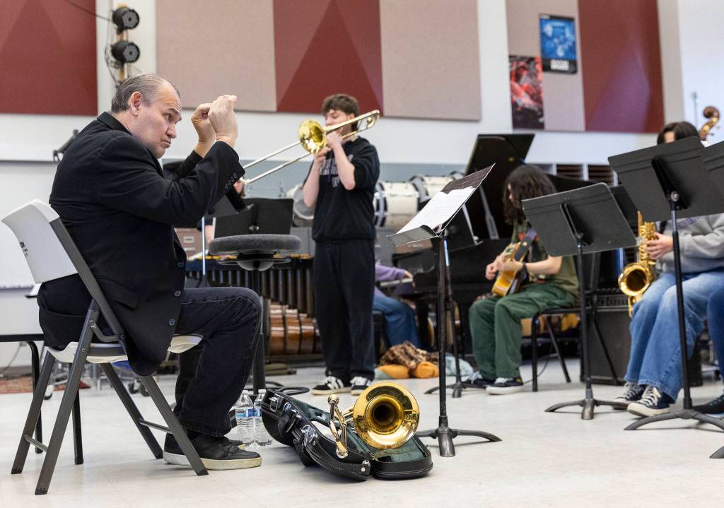 Michael Brady, left, and Gideon Young play trumpets during a band workshop with trombonist Francisco Torres on Monday, March 30, 2026 in Mountlake Terrace, Washington. (Olivia Vanni / The Herald)
