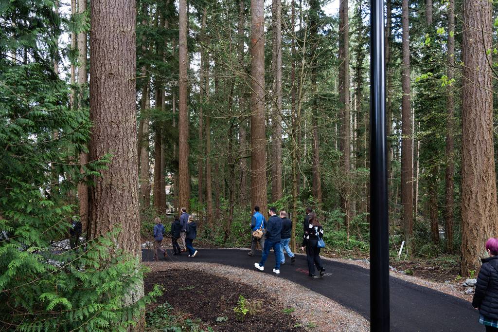 A group tours Veterans Memorial Park on Thursday in Mountlake Terrace. (Will Geschke / The Herald)
