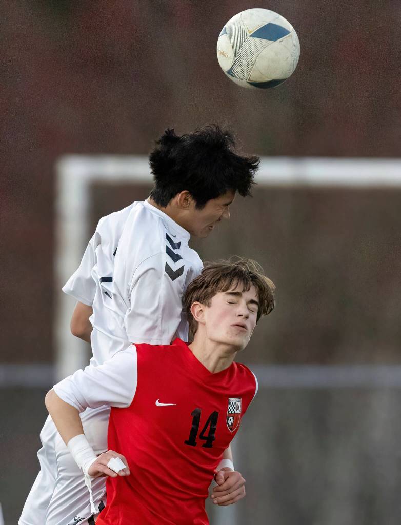 Jacksons Isaac Hsu heads the ball against Snohomishs Brennan Carter during the game on Monday, April 6, 2026 in Snohomish, Washington. (Olivia Vanni / The Herald)