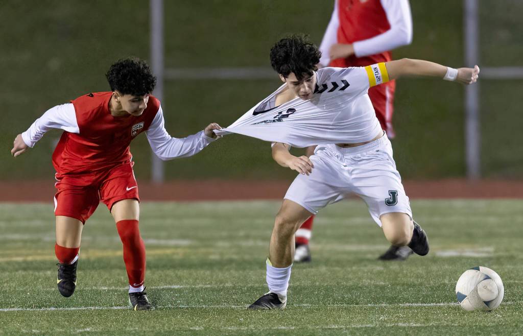 Snohomishs Aurick Arreola-Villasenor grabs the jersey of Jacksons Brady McPherson during the game on Monday, April 6, 2026 in Snohomish, Washington. (Olivia Vanni / The Herald)