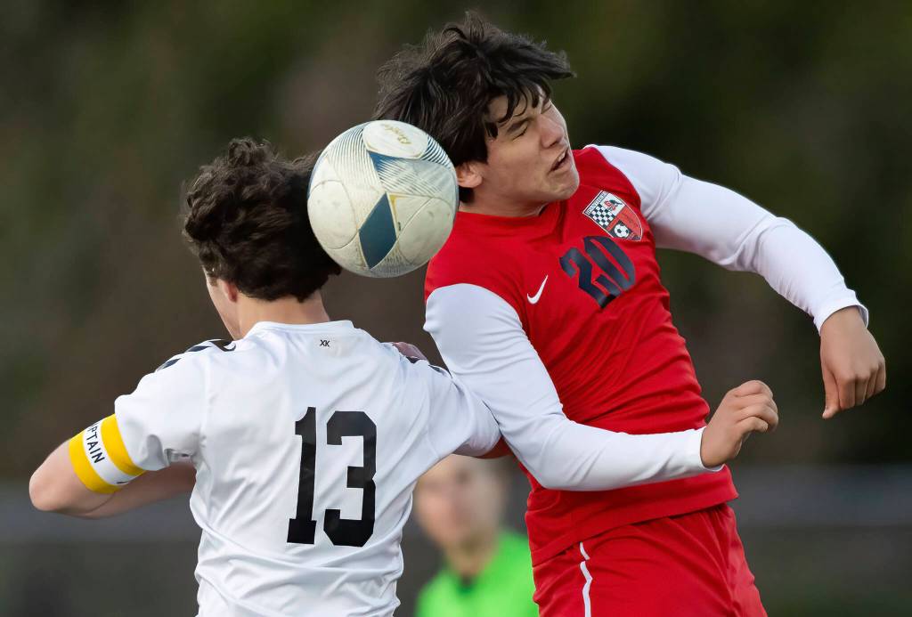 Snohomishs Sonteyago Seeley jumps against Jacksons Caleb Holmstedt to head the ball during the game on Monday, April 6, 2026 in Snohomish, Washington. (Olivia Vanni / The Herald)