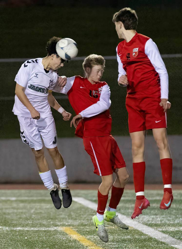 Jacksons Caleb Holmstedt heads the ball against Snohomishs Mitch Mitchell during the game on Monday, April 6, 2026 in Snohomish, Washington. (Olivia Vanni / The Herald)