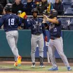 Randy De Jesus (19) of the Tri-City Dust Devils high-fives teammates after scoring the 13th run for the Tri-City Dust Devils in the fourth inning against the Everett AquaSox on Tuesday, April 7, 2026 in Everett, Washington. (Olivia Vanni / The Herald)